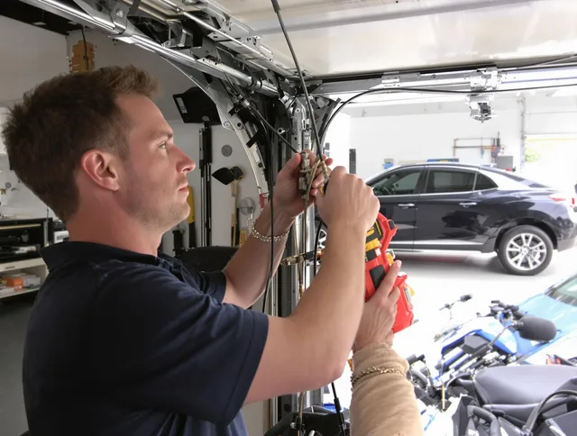 Willowick Garage Door Repair safety certified technician performing cable replacement in Willowick